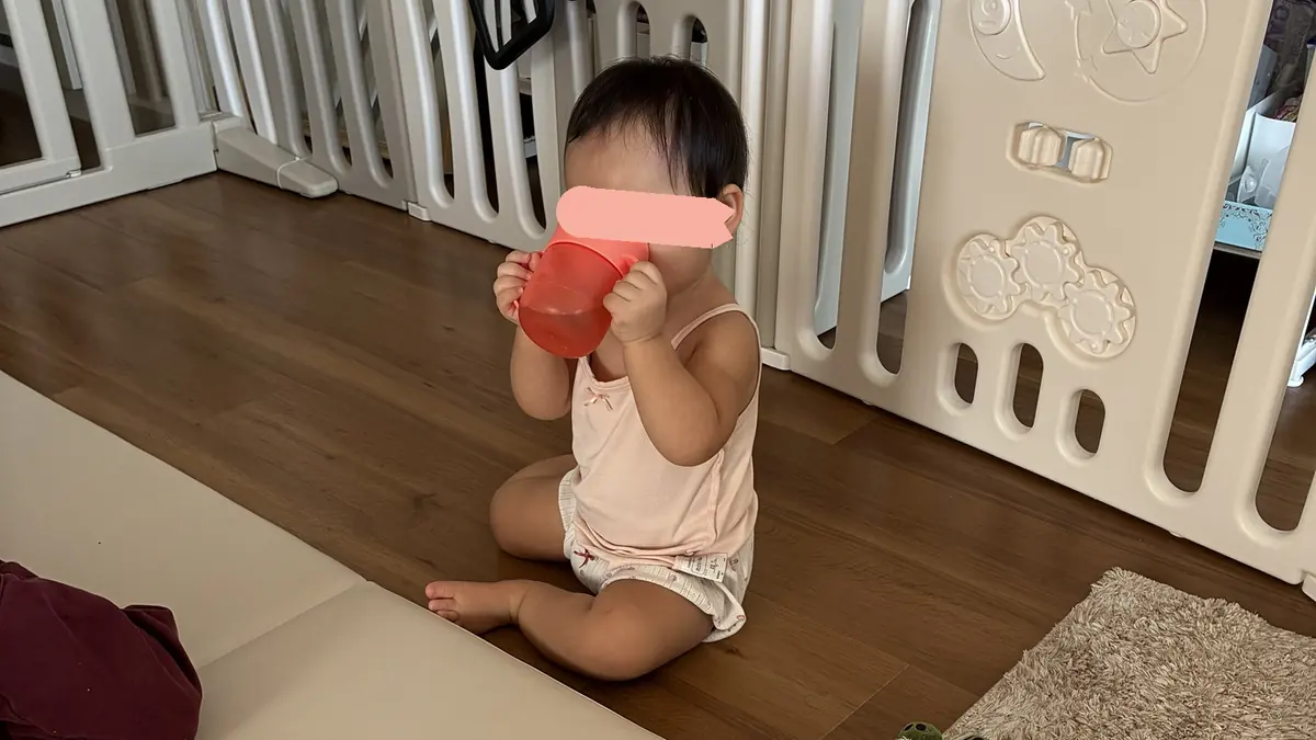 ミラクルカップでお茶を飲む1歳3ヶ月の娘